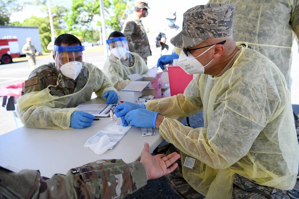 U.S. Air Force Lt. Col. Francisco Nieves, a physician with the 156th Medical Group, Puerto Rico Air National Guard, conducts a COVID-19 rapid test for Puerto Rico National Guard members at Muñiz Air National Guard Base, May 22, 2020.