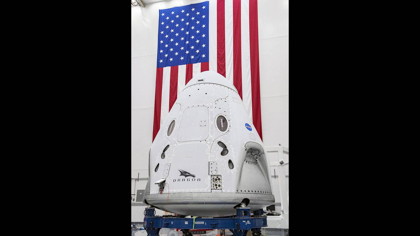 In this April 10, 2020, photo made available by SpaceX, the SpaceX Crew Dragon spacecraft undergoes final processing at Cape Canaveral Air Force Station, Fla.