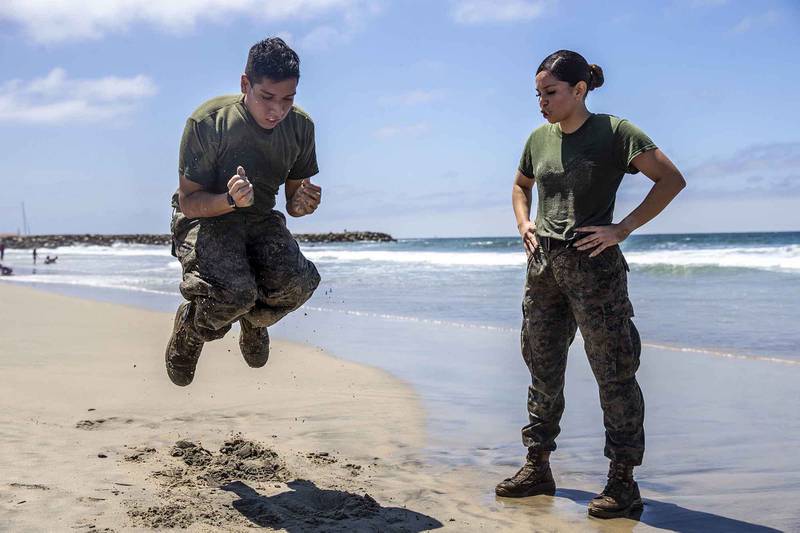 U.S. Marine Sgt. Roxanne Gorostieta motivates a fellow Marine during a physical training session at Del Mar Beach on Marine Corps Base Camp Pendleton, Calif., Aug. 5, 2020.