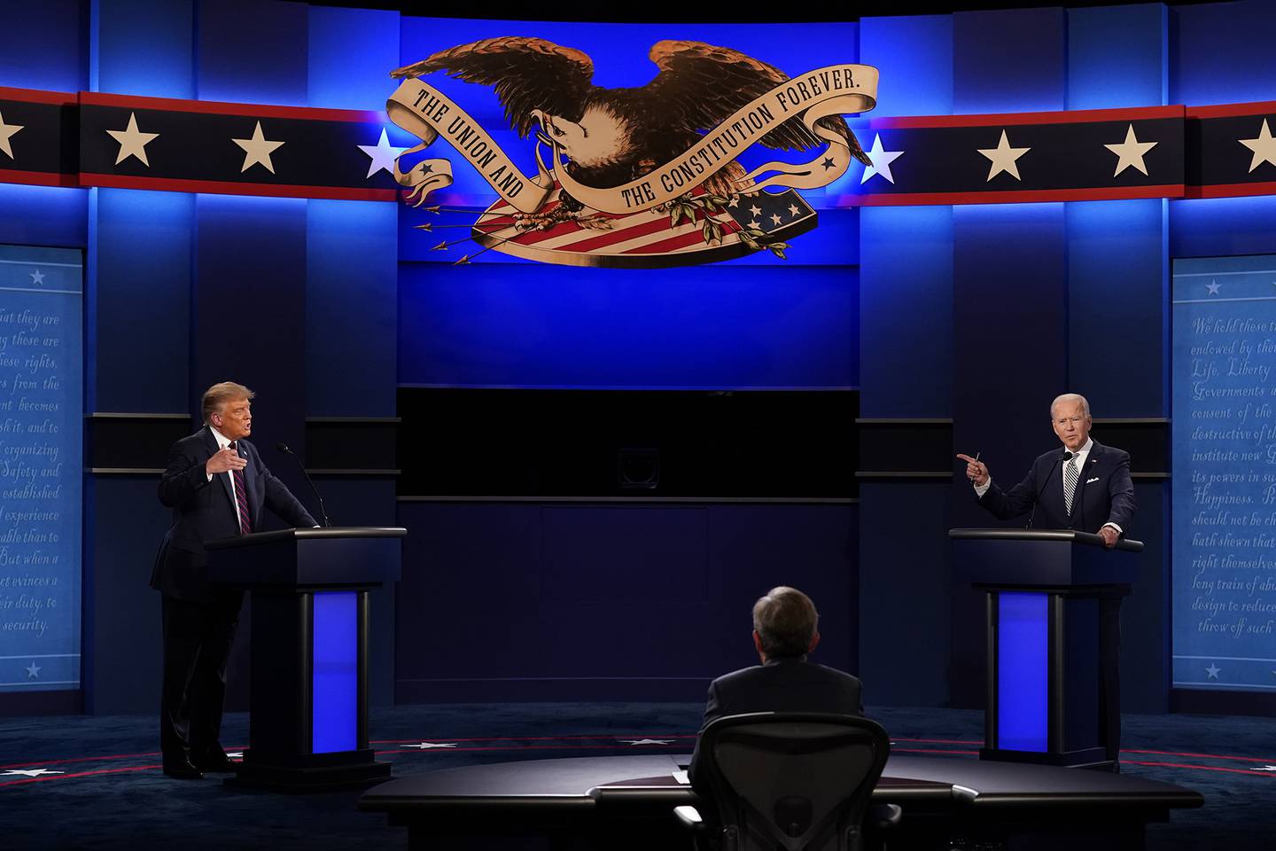 President Donald Trump, left, and Democratic presidential candidate former Vice President Joe Biden, right, with moderator Chris Wallace, center, of Fox News during the first presidential debate Tuesday, Sept. 29, 2020, at Case Western University and Cleveland Clinic, in Cleveland.