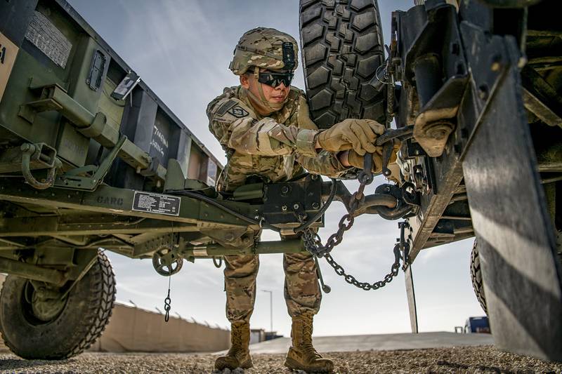 Pvt. 1st Class Pablo Aguirre secures an M1101 trailer to the back of a high mobility multipurpose wheeled vehicle on Dec. 22, 2020, in support of Spartan Shield.