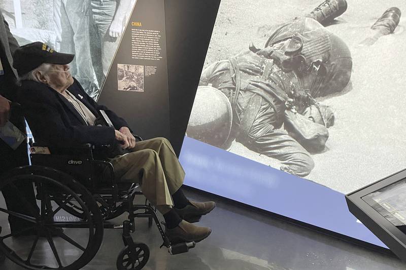 A World War II veteran looks an exhibit at the National WWII Museum's new Liberation Pavilion in New Orleans on Friday, Nov. 3, 2023.