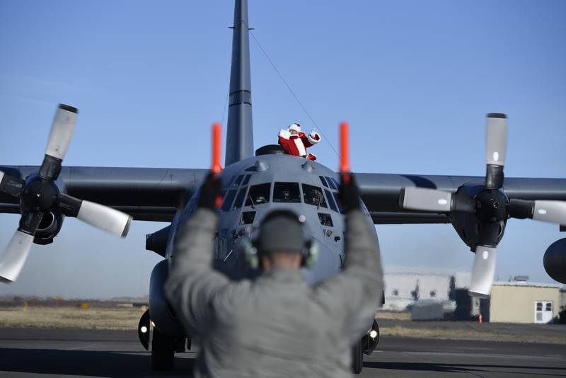 Santa Claus waves as he taxis on the ramp in a 120th Airlift Wing C-130 Hercules at Montana Air National Guard Base on Dec. 5, 2020.