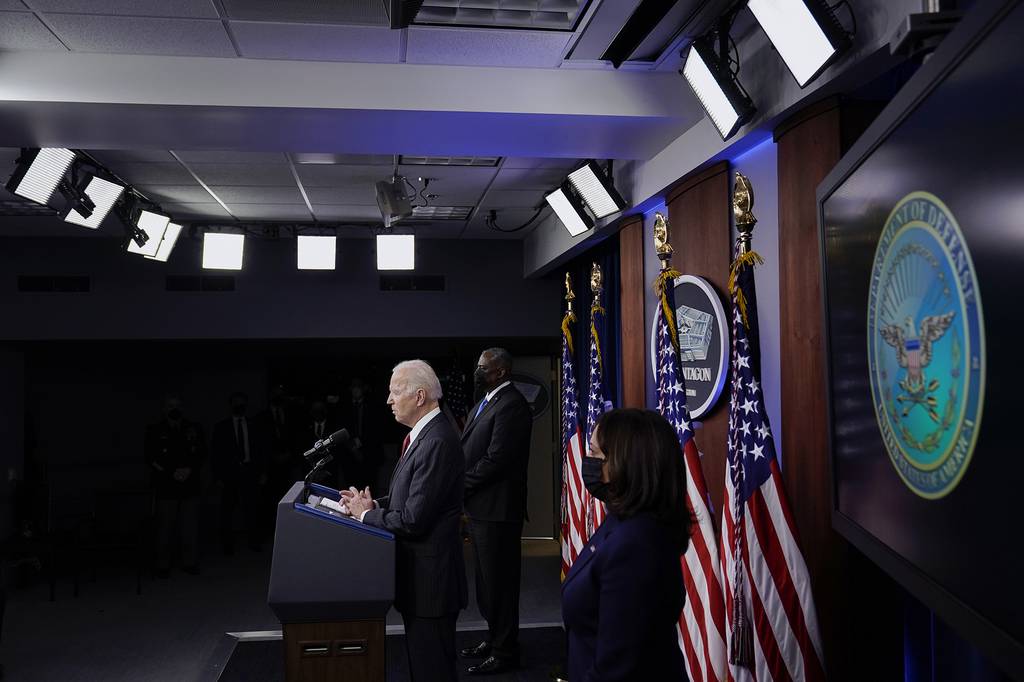 President Joe Biden speaks as Secretary of Defense Lloyd Austin and Vice President Kamala Harris accompany him at the Pentagon, Wednesday, Feb. 10, 2021, in Washington.