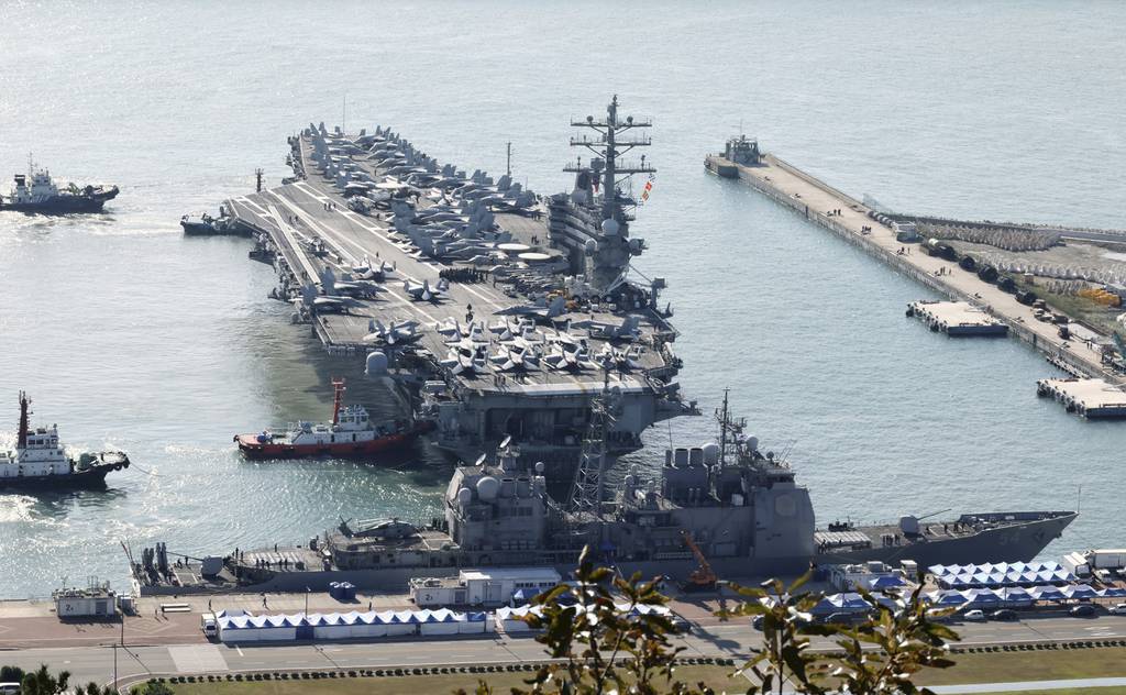 U.S. nuclear-powered aircraft carrier Ronald Reagan is escorted as it arrives in Busan, South Korea, Thursday, Oct. 12, 2023.