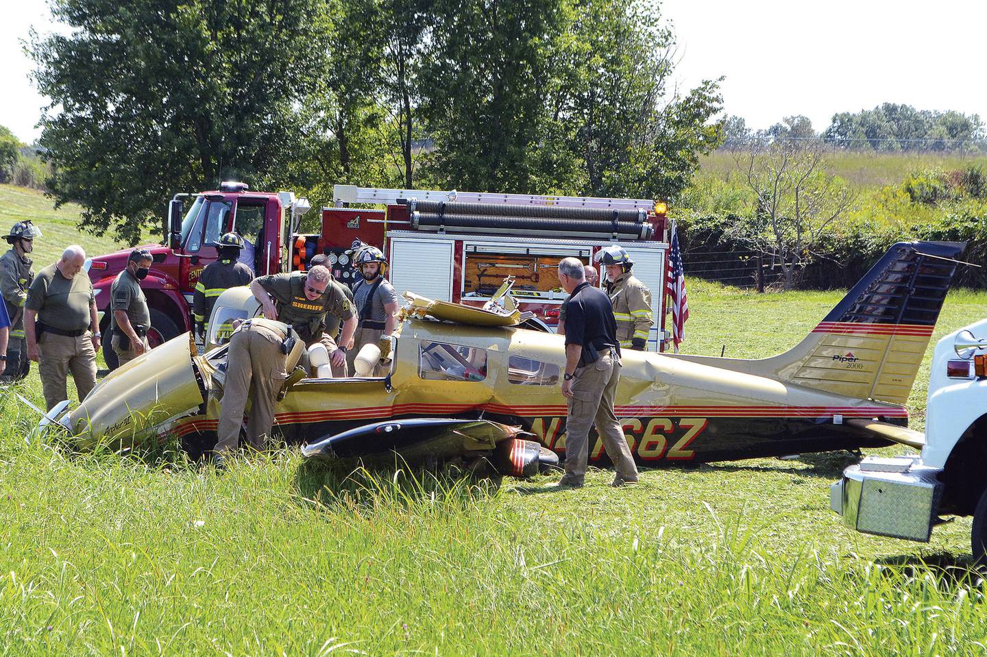 Investigators examine a single-engine Piper that crashed in a field off Airport Lake Road on Tuesday, Sept. 8, 2020, near Warren County Memorial Airport in McMinnville, Tenn.