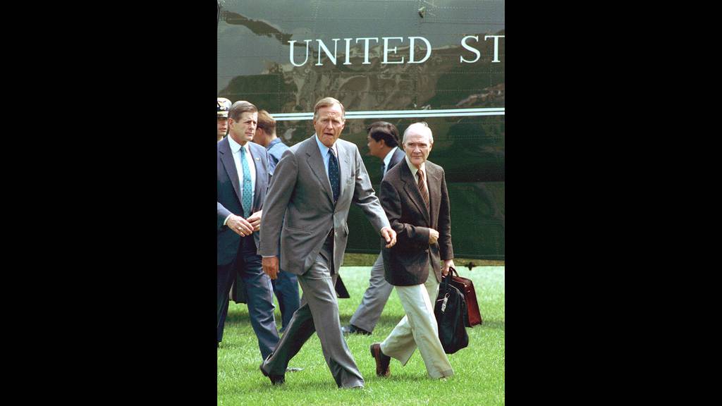 In this August 19, 1991, file photo, President George Bush, accompanied by national security adviser Brent Scowcroft, right, arrives back at the White House after he interrupted his vacation following the overthrow of Soviet President Gorbachev.