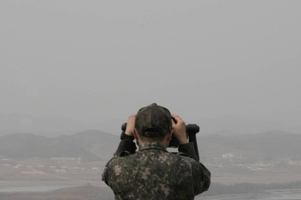 A South Korean army soldier watches the North Korea side from the Unification Observation Post in Paju, South Korea, near the border with North Korea, Friday, March 24, 2023.