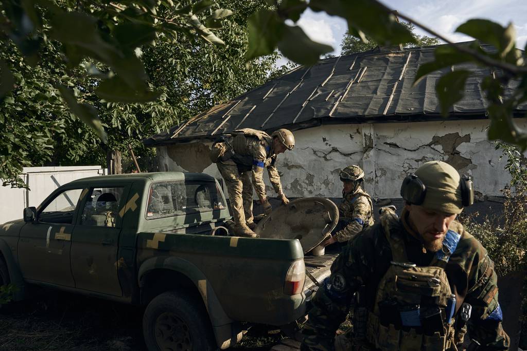 Ukrainian soldiers unload ammunition in the recently retaken Kupiansk in the Kharkiv region, Ukraine, Thursday, Sept. 22, 2022.