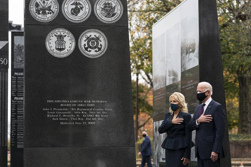 President-elect Joe Biden, and Jill Biden, stand with their hands over their hearts before placing a wreath at the Philadelphia Korean War Memorial at Penn's Landing, on Veterans Day, Wednesday, Nov. 11, 2020, in Philadelphia.
