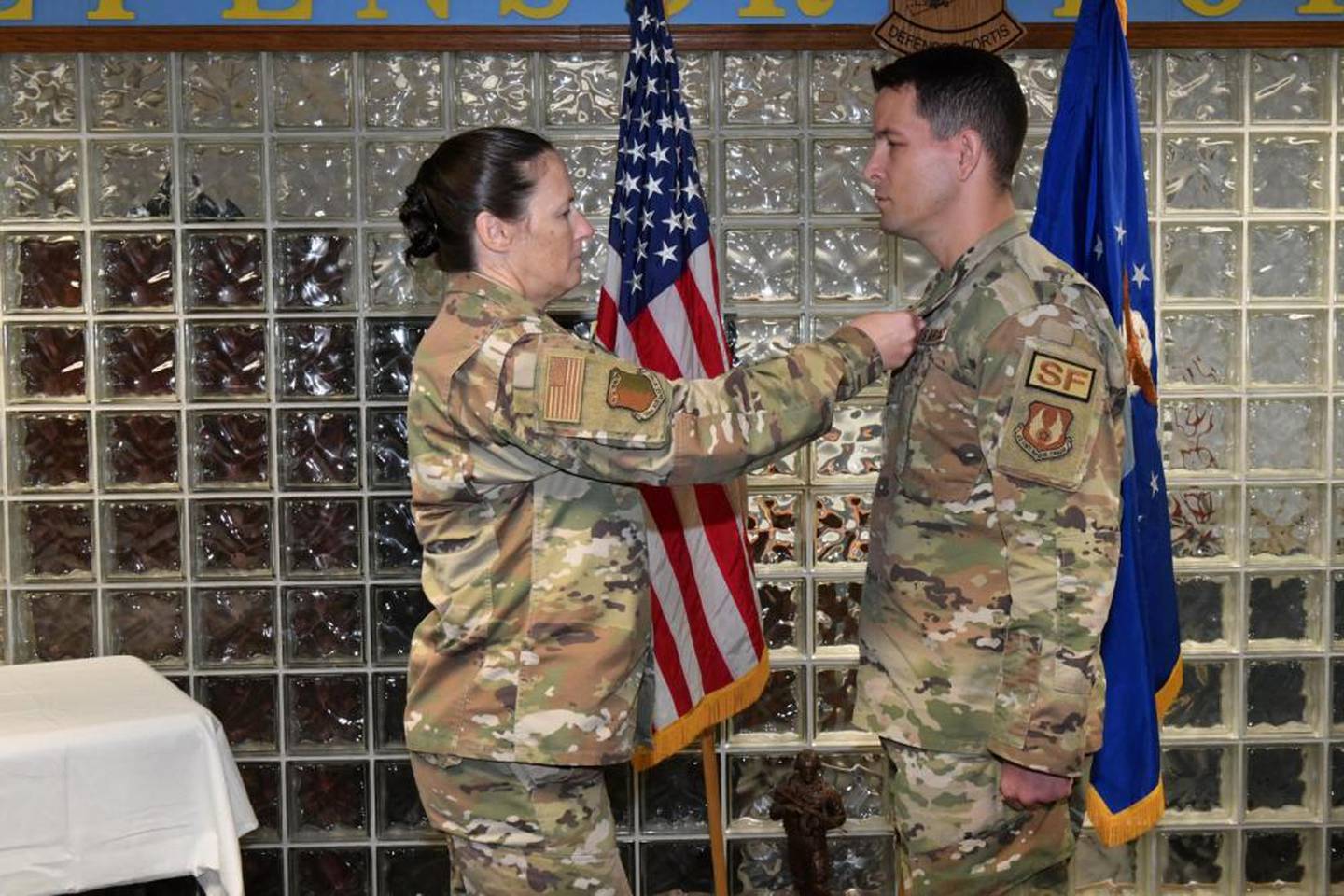 Col. Lindsay Droz, 78th Air Base Wing commander, left, decorates Master Sgt. Mathue B. Snow, 78th Security Forces Squadron, with the Bronze Star at Robins Air Force Base, Georgia, Sept. 9, 2022. Snow was decorated for actions during the Jan. 5, 2020, attack on Manda Bay, Kenya, where one American soldier and two Department of Defense civilian contractors died, and six U.S. aircraft and one Kenyan aircraft were destroyed. (Rodney Speed/Air Force)