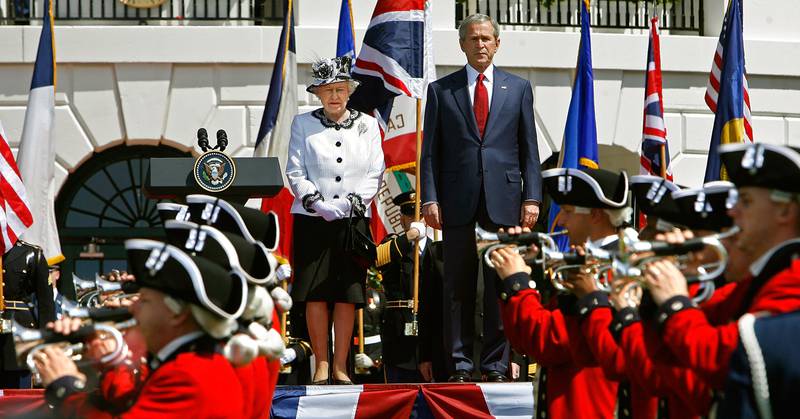 Queen Elizabeth II and U.S. President George W. Bush watch the U.S. Army's Old Guard Fife and Drum Corps march on the South Lawn of the White House May 7, 2007 in Washington, DC.