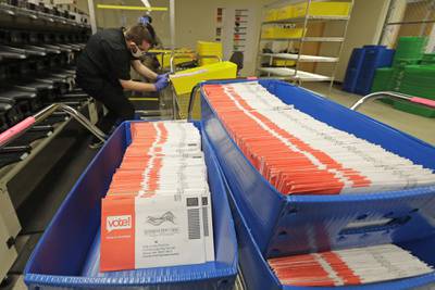 Vote-by-mail ballots are shown in sorting trays on Aug. 5, 2020, at the King County Elections headquarters in Renton, Wash., south of Seattle.