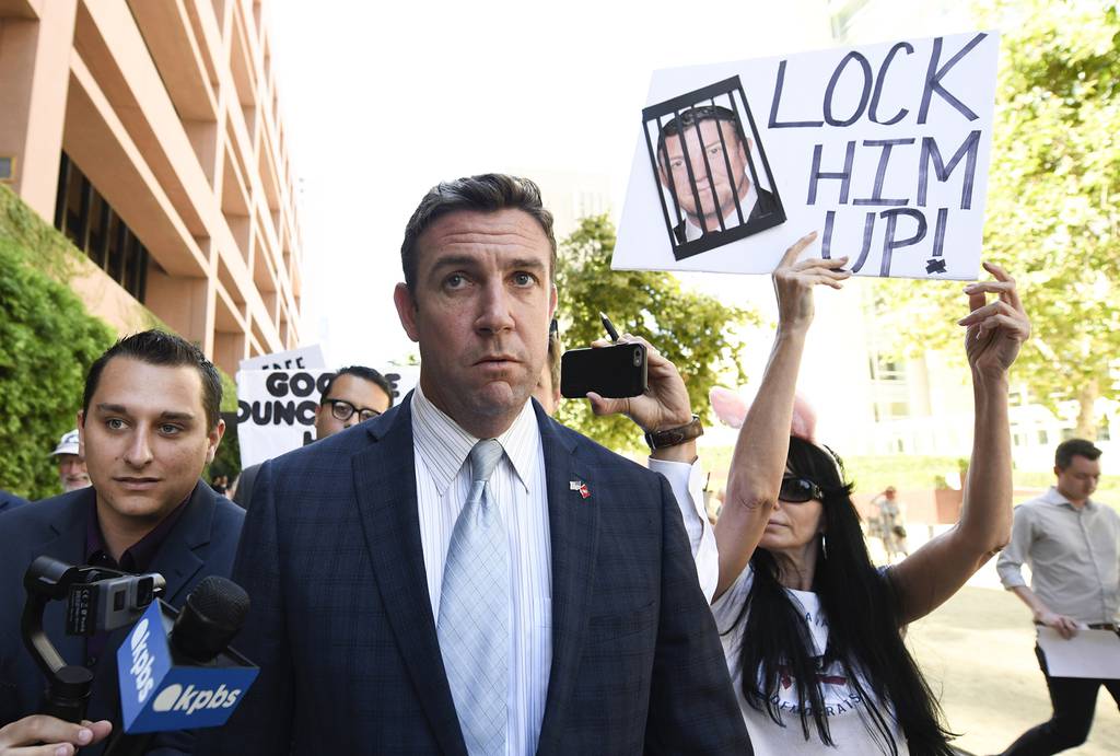 In this July 1, 2019, file photo, U.S. Rep. Duncan Hunter, R-Calif., center, leaves federal court after a hearing in San Diego.