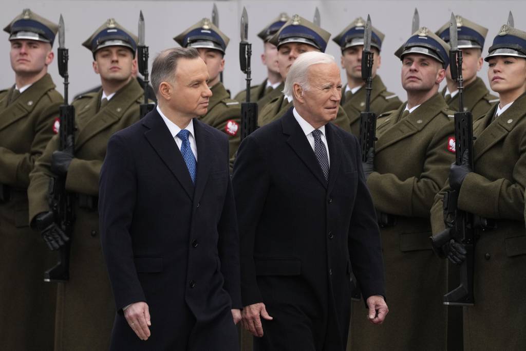 Polish President Andrzej Duda, left, welcomes President Joe Biden at the Presidential Palace in Warsaw, Ukraine, Tuesday, Feb. 21, 2023