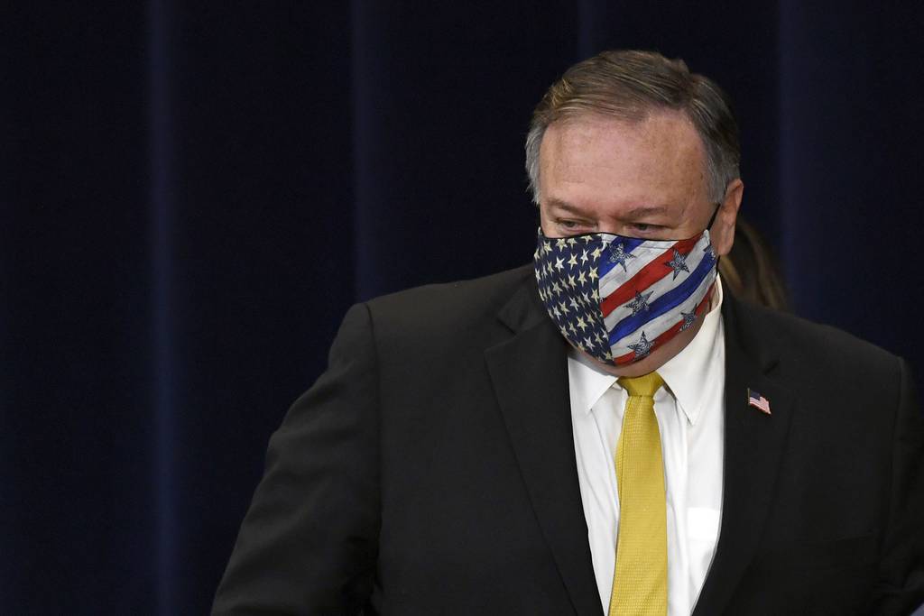 Secretary of State Mike Pompeo walks off of the stage following a news conference at the State Department in Washington, Wednesday, Aug. 19, 2020, with Iraqi Foreign Minister Fuad Hussein.