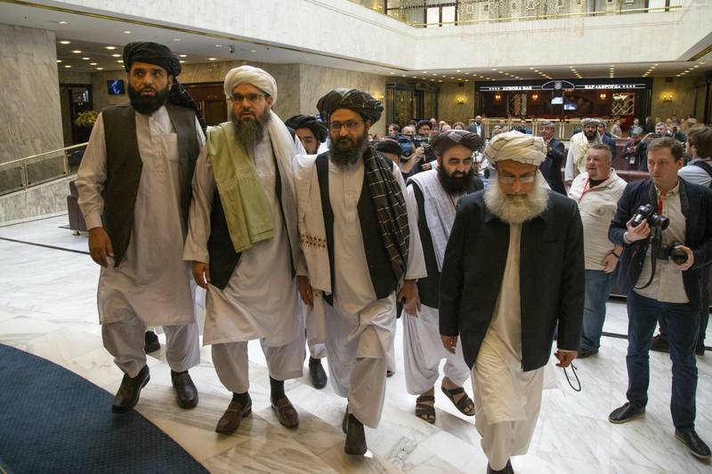 Mullah Abdul Ghani Baradar, the Taliban group's top political leader, third from left, arrives with other members of the Taliban delegation for talks in Moscow.