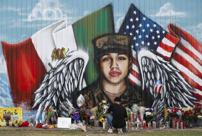 Juan Cruz, boyfriend of Army soldier Vanessa Guillén, kneels in front of a mural honoring her on July 5, 2020, in Houston.