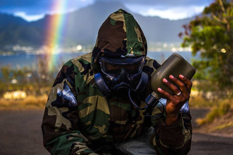 A Marine drinks water while in full mission oriented protective posture (MOPP) gear during a unit-held uphill run on Marine Corps Base Hawaii, June 11, 2020.