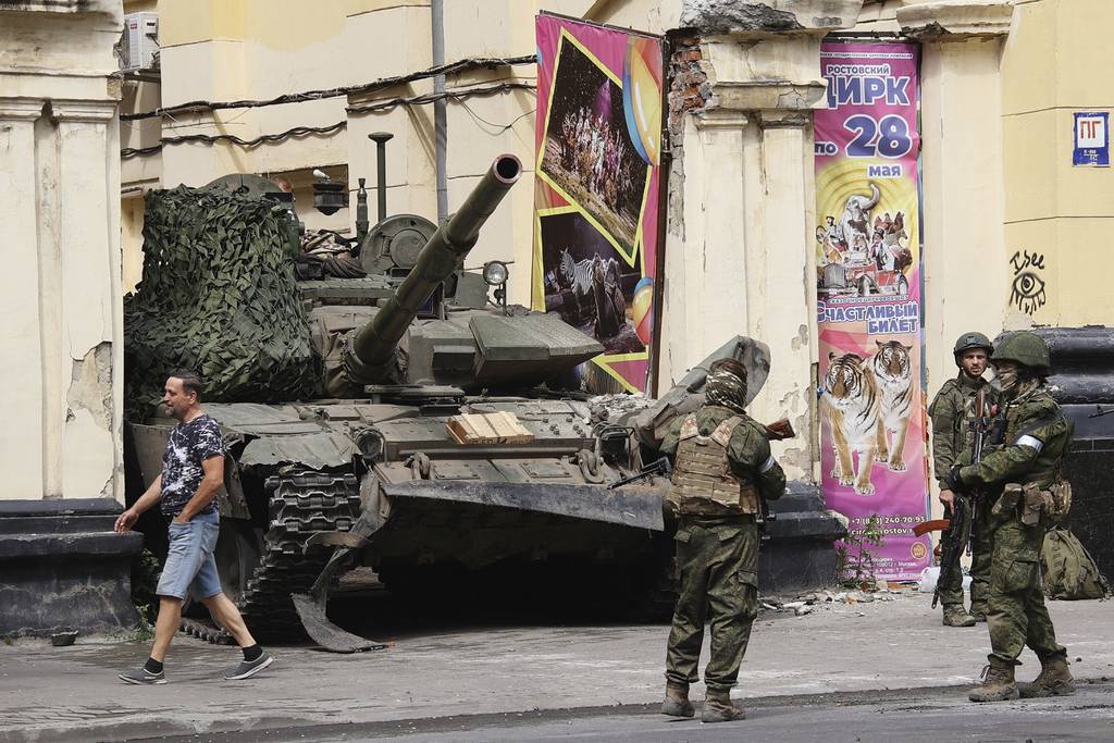 Members of the Wagner Group military company guard an area standing in front of a tank in a street in Rostov-on-Don, Russia, Saturday, June 24, 2023.