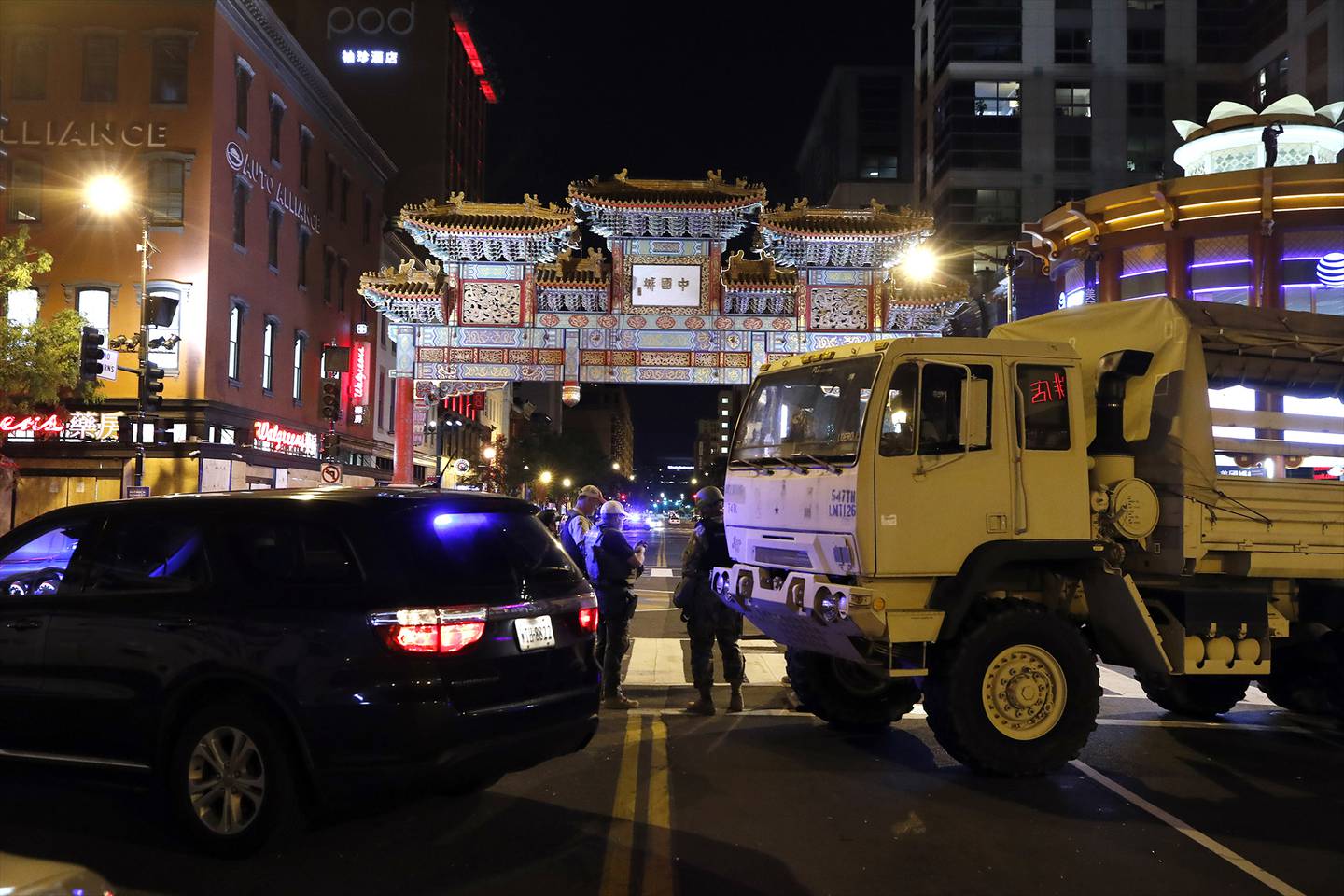 A military Humvee blocks an intersection in the Chinatown section of downtown Washington as demonstrators protest the death of George Floyd, Monday, June 1, 2020, in Washington.