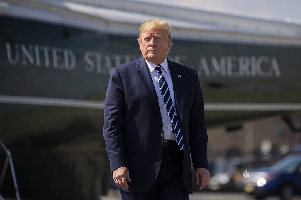 In this July 21, 2019 file photo, President Donald Trump walks on the tarmac to board Air Force One at Morristown Municipal Airport in Morristown, N.J.