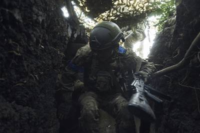 A soldier of Ukraine's 3rd Separate Assault Brigade jumps in a trench under the shelling near Bakhmut, the site of fierce battles with the Russian forces in the Donetsk region, Ukraine, Monday, Sept. 4, 2023.