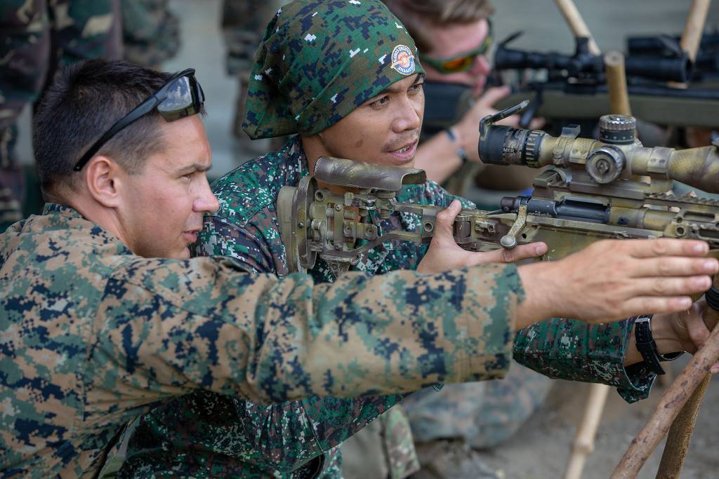 A U.S. Marine shares his knowledge of the M40A6 sniper rifle with a Philippine Marine during KAMANDAG 3 at Fort Magsaysay, Philippines, Oct. 14, 2019.