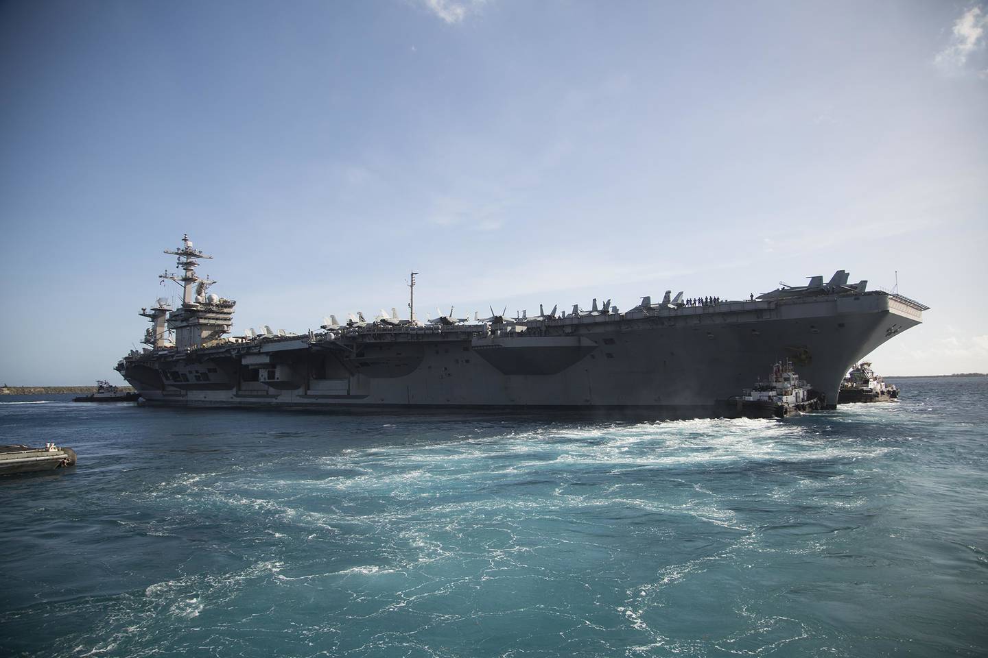The aircraft carrier USS Theodore Roosevelt (CVN 71) departs Apra Harbor on May 21, 2020, following an extended visit to Guam in the midst of the COVID-19 global pandemic.