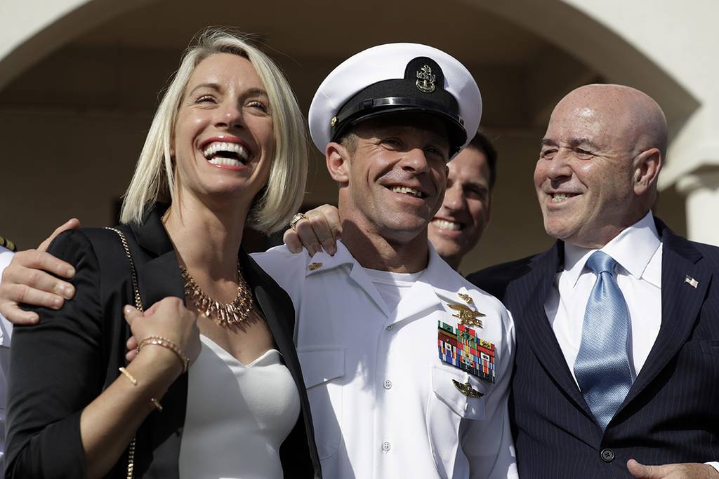 Navy Special Operations Chief Edward Gallagher, center, walks with his wife, Andrea Gallagher, left, and advisor, Bernard Kerik as they leave a military court on Naval Base San Diego, Tuesday, July 2, 2019, in San Diego.