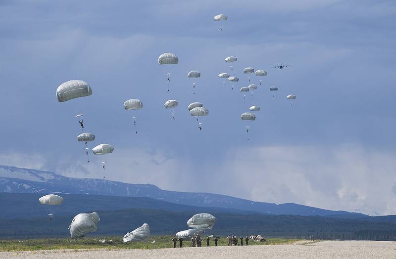 Members from the U.S. Army 377th Parachute Field Artillery Regiment complete a static line jump from a U.S. Air Force C-130 Hercules during RED FLAG-Alaska, June 13, 2019, at Donnelly Drop Zone near Fort Greely, Alaska.