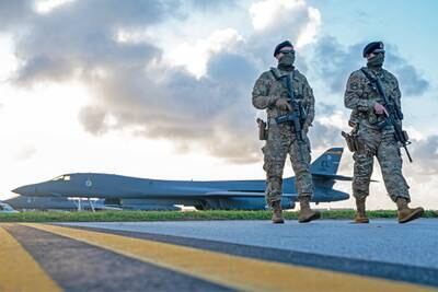 Security forces airmen patrol near a U.S. Air Force B-1B Lancer taxiway at Andersen Air Force Base, Guam, in support of a Bomber Task Force mission, Dec. 26, 2020.