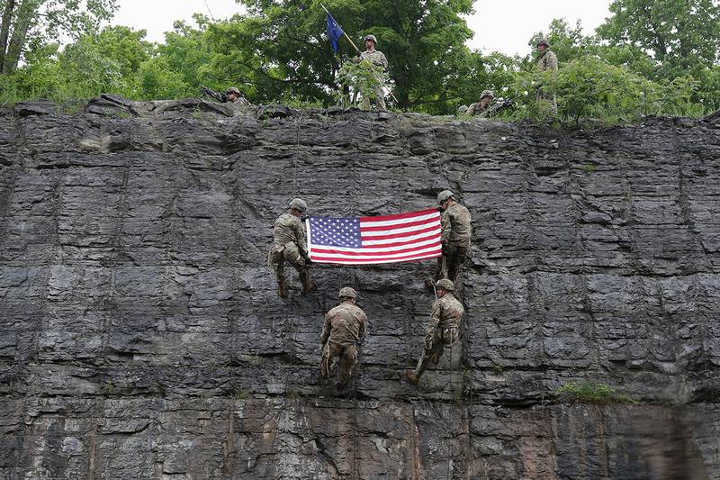 Spc. Scott Myers, lower left, re-enlists during rock face rappel training at Fort Drum, N.Y., June 13, 2019.