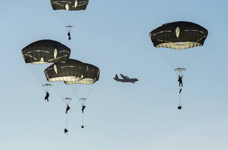 Paratroopers descend over Malemute Drop Zone after jumping from a U.S. Air Force C-130J Super Hercules during airborne training at Joint Base Elmendorf-Richardson, Alaska, Oct. 22, 2020.