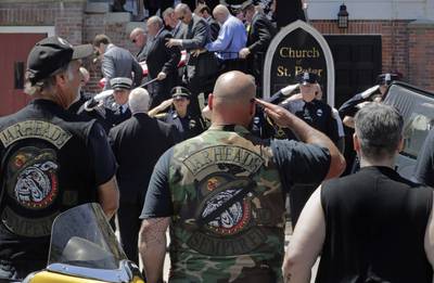 Members of the Jarheads Motorcycle Club and a police honor guard salute as the casket of Michael Ferazzi is loaded into a hearse outside St. Peter's Catholic Church in Plymouth, Mass., Friday, June 28, 2019.