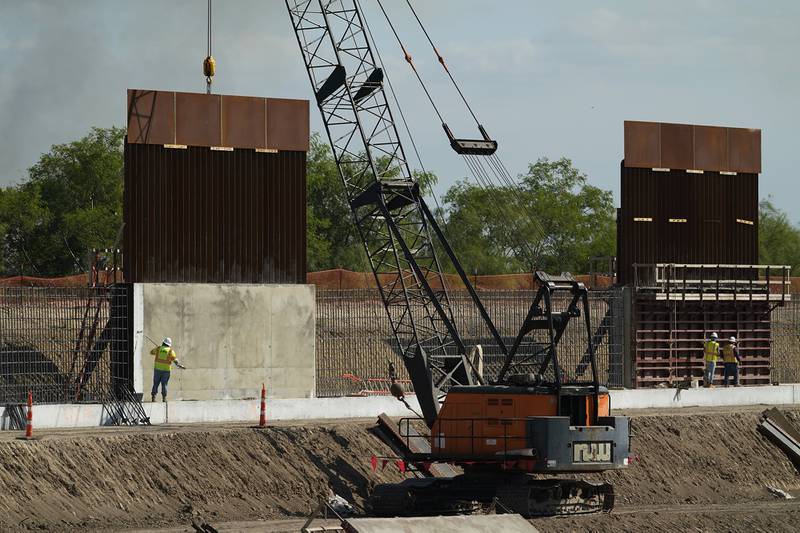 Construction workers build a border wall in Mission, Texas, Monday, Nov. 16, 2020.