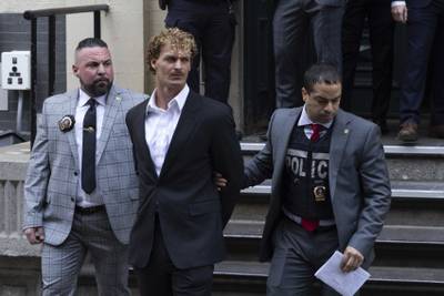 Daniel Penny, center, is walked by New York Police Department detectives detectives out of the 5th Precinct on Friday, May. 12, 2023 in New York.
