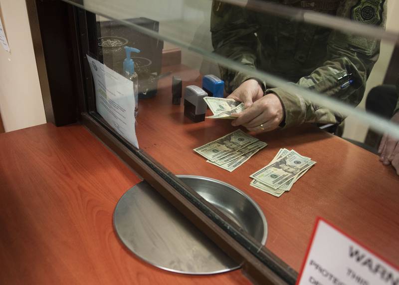 An airman counts cash for a customer’s withdrawal request as part of his immersion tour with the wing staff agency July 30, 2020, at Incirlik Air Base, Turkey.