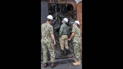 Secretary of the Navy Kenneth J. Braithwaite tours fire damage aboard the amphibious assault ship USS Bonhomme Richard (LHD 6) during a visit to the ship at Naval Base San Diego on July 27, 2020