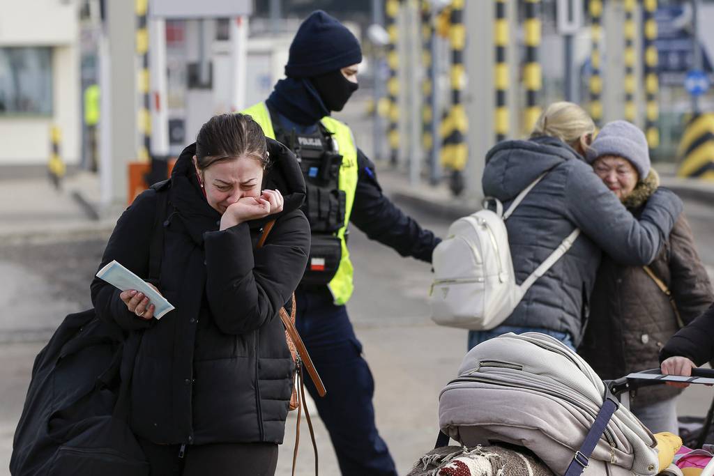 Family members hug as they reunite, after fleeing conflict in Ukraine, at the Medyka border crossing, in Poland, Sunday, Feb. 27, 2022. Since Russia launched its offensive on Ukraine, more than 200,000 people have been forced to flee the country to bordering nations like Romania, Poland, Hungary, Moldova, and the Czech Republic — in what the U.N. refugee agency, UNHCR, said will have "devastating humanitarian consequences" on civilians. (AP Photo/Visar Kryeziu)