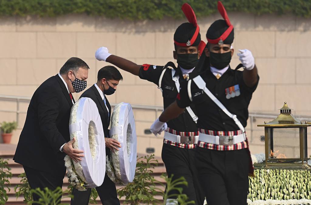 U.S. Secretary of State Mike Pompeo, left, and Secretary of Defense Mark Esper pay their tributes at the National War Memorial in New Delhi, India, Tuesday, Oct. 27, 2020.