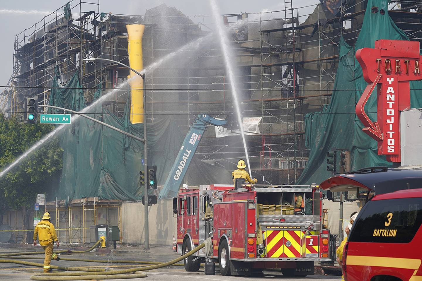 Firefighters work the scene of fire at a five-story housing complex under construction in East Los Angeles early on Sept. 16, 2020.