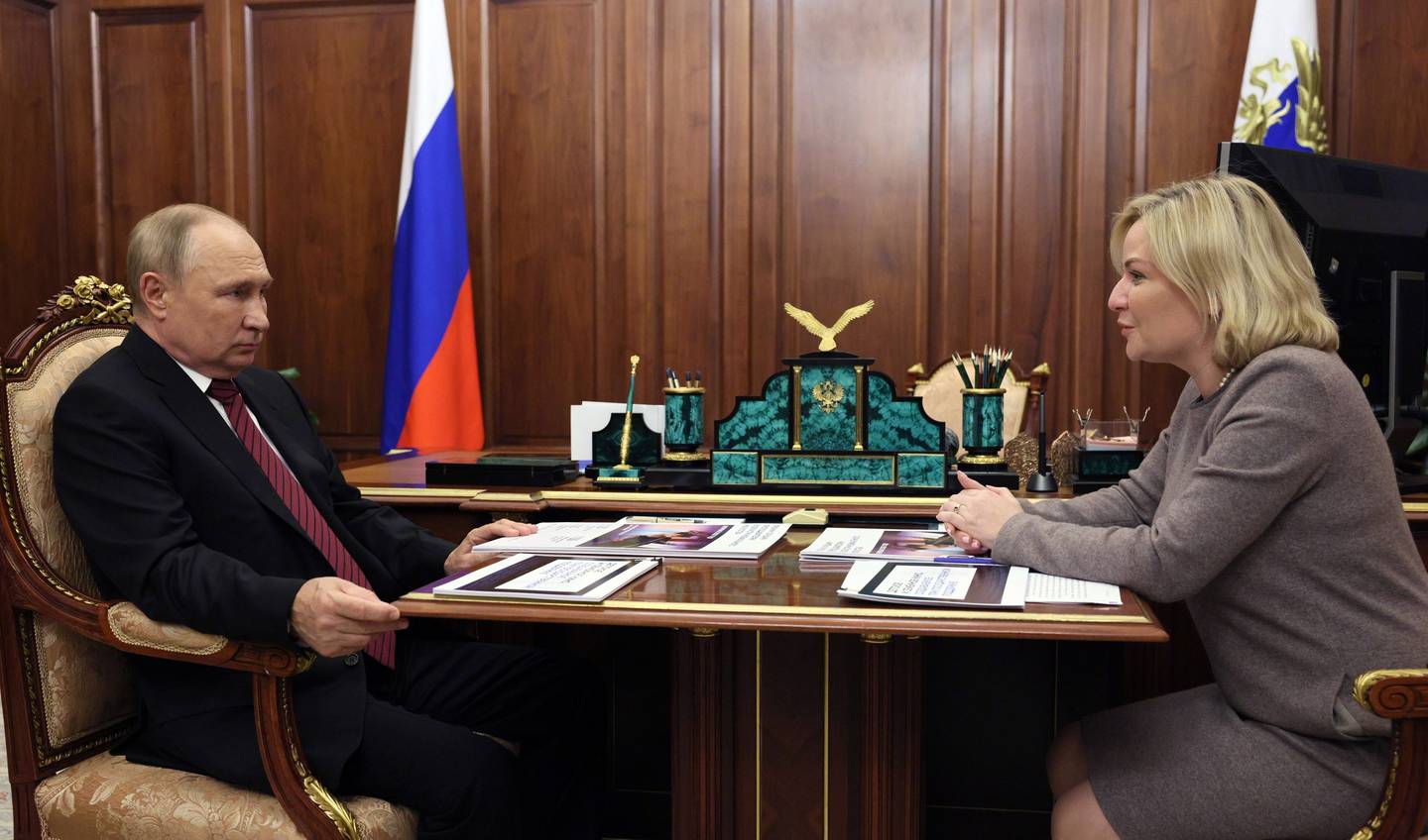 Russian President Vladimir Putin listens to Russian Culture Minister Olga Lyubimova during their meeting in Moscow, Russia, Oct. 3, 2022.