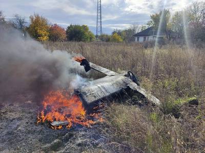 In this photo provided by the Ukrainian Defense Ministry Press Service, fragments of a Russian rocket that was shot down by the Ukrainian air defense system burn down in the village of Kipti, Chernihiv region, Ukraine, Wednesday, Oct. 19, 2022.