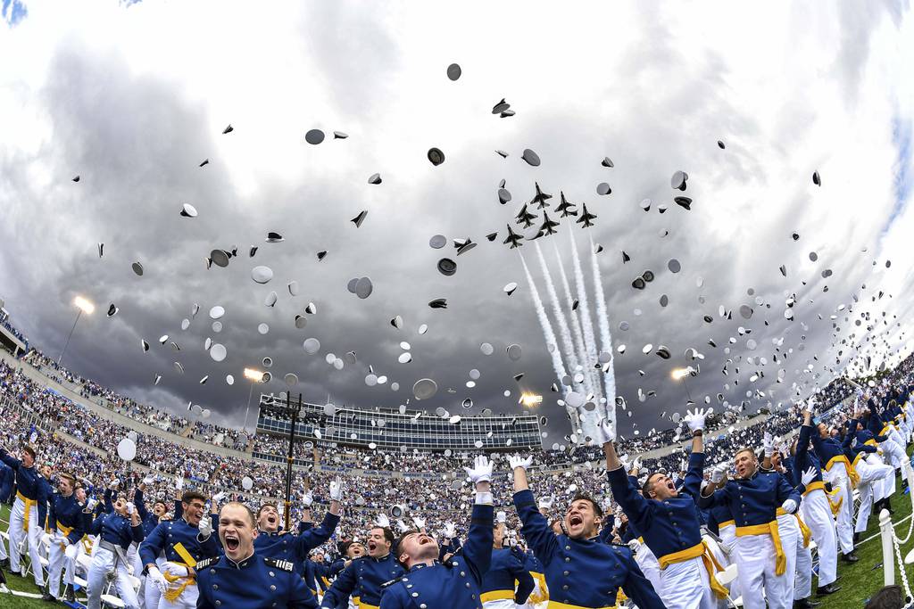 Air Force Academy cadets toss their caps in the air as the Thunderbirds fly overhead during the 2023 graduation ceremony June 1 in Colorado Springs, Colo.