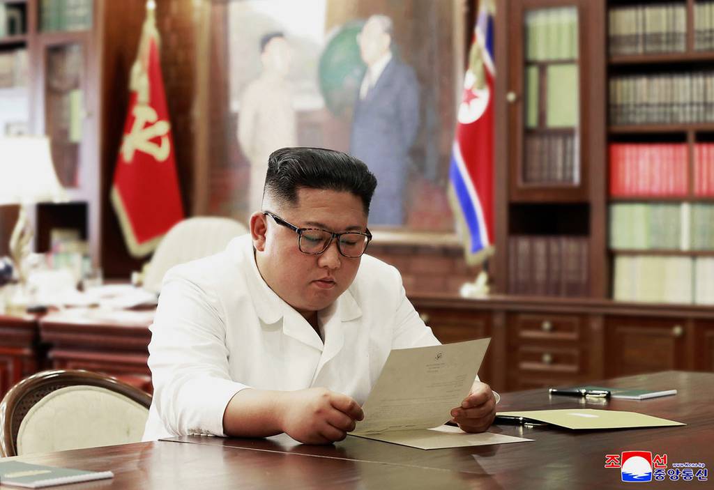 North Korean leader Kim Jong Un reads a letter from U.S. President Donald Trump.