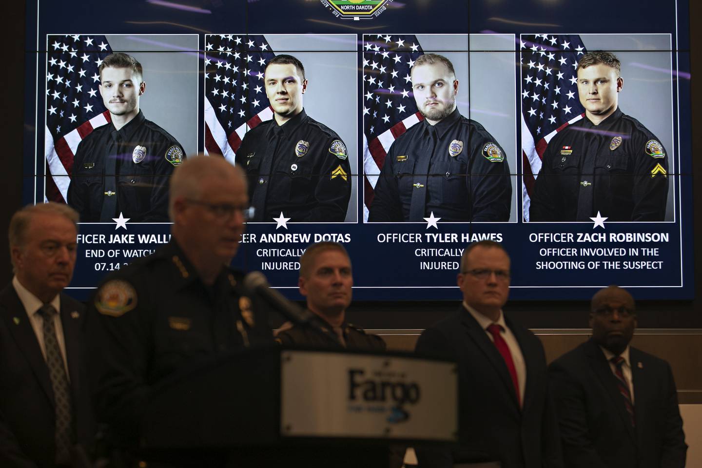 Official portraits of Fargo, N.D., police officers involved in a shooting a day earlier are displayed during a news conference, Saturday, July 15, 2023, at Fargo City Hall.
