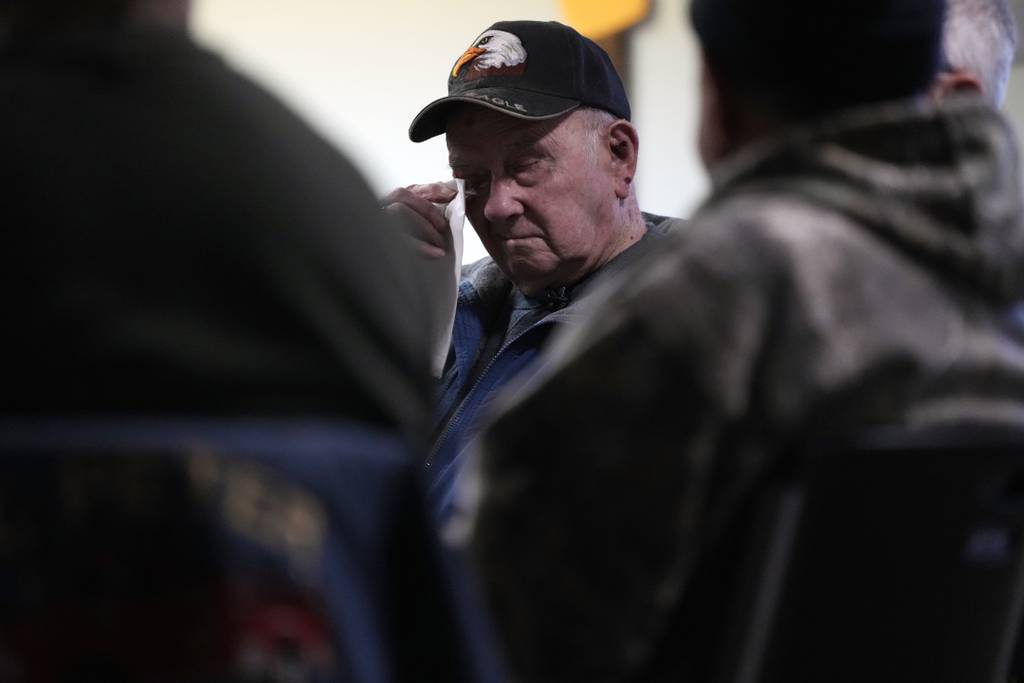 Earl Meyer, who fought for the U.S. Army in the Korean War, wipes away a tear while talking with fellow veterans at the American Legion, Tuesday, Nov. 7, 2023, in St. Peter, Minn.