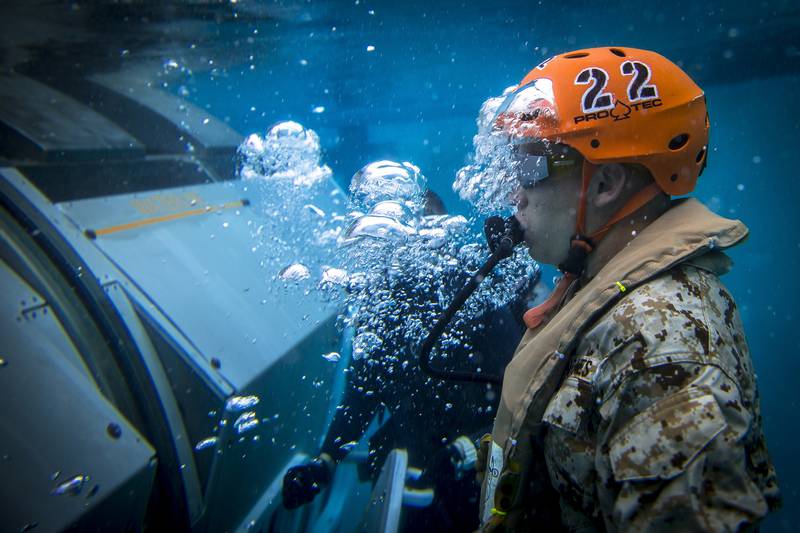 A Marine escapes from a Modular Amphibious Egress Trainer