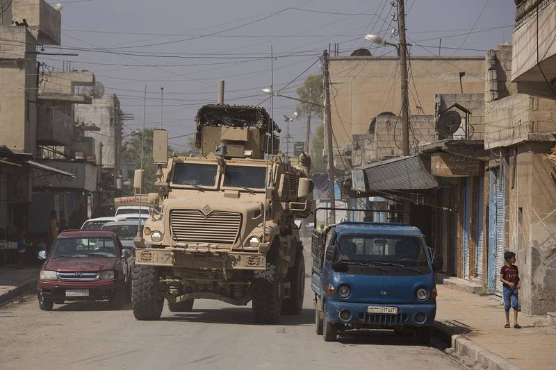 A U.S. armored vehicle drives through Tal Abyad, Syria, on a joint patrol with the Tax Abyad Military Council, an affiliate of the U.S.-backed Syrian Democratic Forces Friday, Sept. 6, 2019.